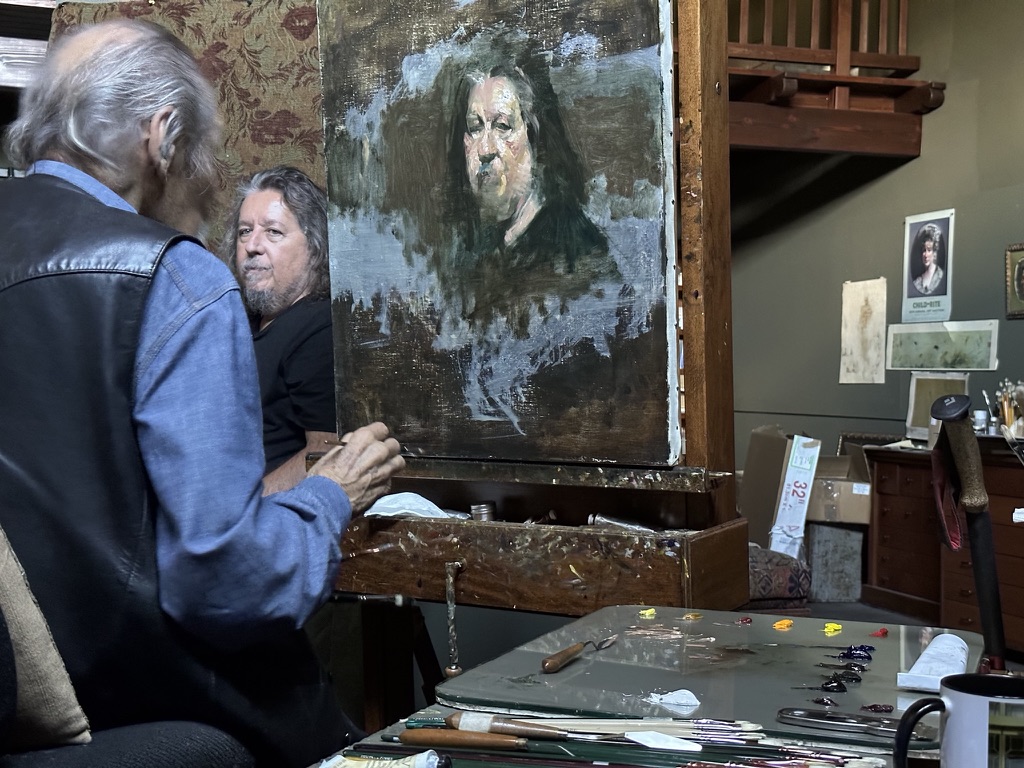Master Artist David Leffel painting Joe D'Arcy, with the portrait on the easel, Arroyo Seco, New Mexico 2023. Photograph by Carol D'Arcy.